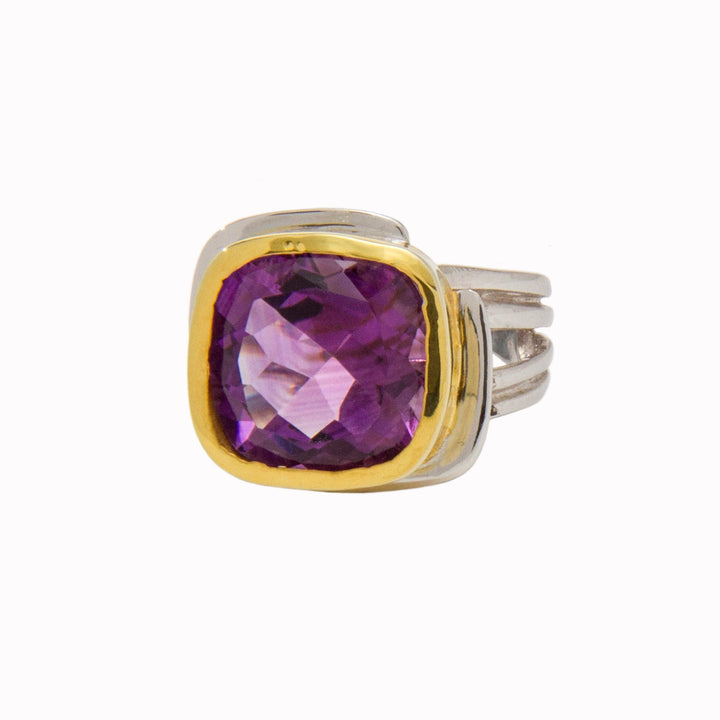 This **Art Deco Ring in Silver Gold & various gemstones** by **Gallardo & Blaine Designs**, made of sterling silver with a gold vermeil bezel, features a large, square-cut purple gemstone. The band elegantly splits into three sections, creating a sturdy and sophisticated appearance. The gemstone catches light beautifully, displaying a mesmerizing range of purple hues.