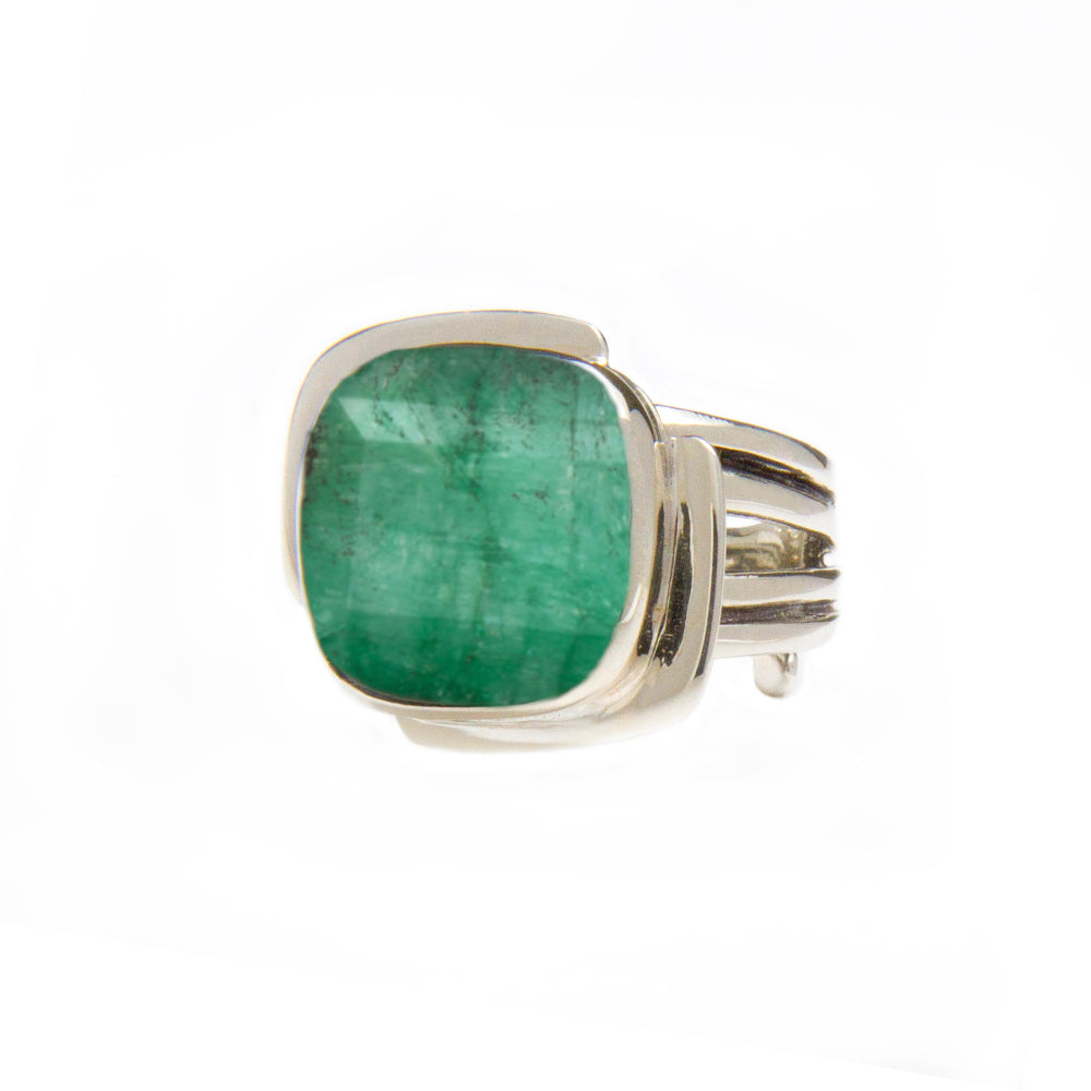 A Gallardo & Blaine Designs Art Deco Ring in Silver Gold & various gemstones featuring a large square-cut green gemstone held by a sleek and modern band design. The green gemstone is the focal point, contrasting beautifully against the polished silver band reminiscent of an Art Deco ring. The background is plain white.