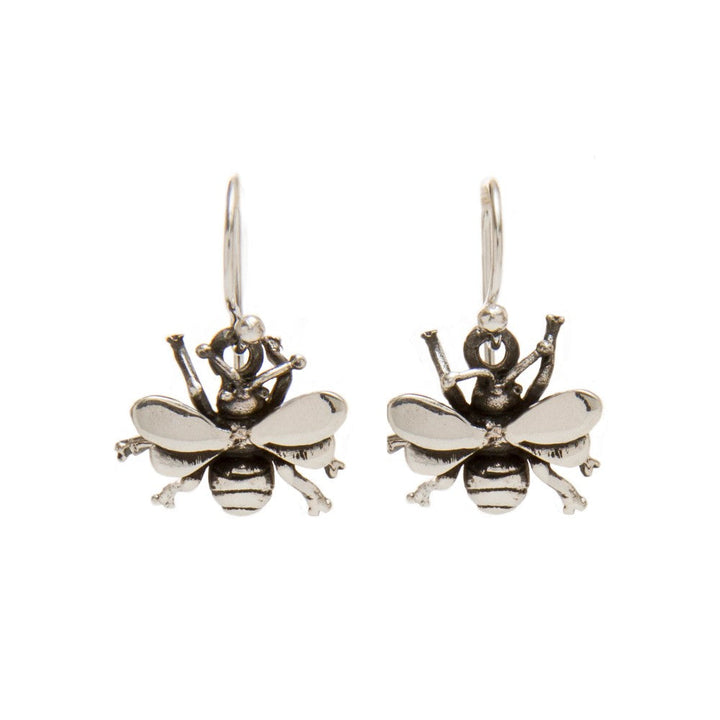 A pair of silver Wildlife Bee Dangle Earrings by Gallardo & Blaine Designs shaped like detailed, realistic bees. Each earring features a bee with spread wings, segmented body, and fine details on the head and legs, hanging from a simple hook. This wildlife-themed jewelry is perfect for any pollinators accessory collection.