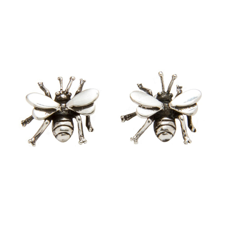 Two sterling silver bee-shaped earrings with detailed wings and bodies. The design is symmetrical, and each earring features intricate patterns resembling a bee's anatomy. Part of our Wildlife Collection, these studs have a shiny finish, highlighting the craftsmanship. Our Wildlife Bee Studs from Gallardo & Blaine Designs are perfect for nature lovers seeking an elegant yet whimsical accessory.