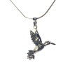 A Gallardo & Blaine Designs Wildlife Pendant - Bird In Flight With Chain from the Wildlife Collection featuring a detailed hummingbird pendant. The bird in flight pendant boasts intricate designs on its wings and body, giving it a delicate and elegant appearance. The simple silver chain complements the ornate design of the hummingbird beautifully.