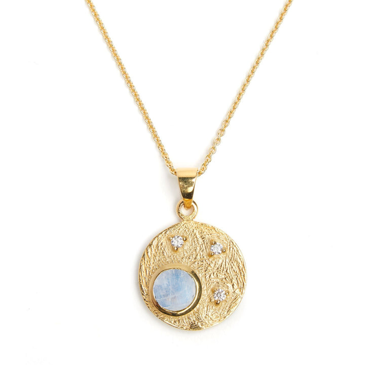 A delicate Celeste Necklace in Gold & various gemstones by Gallardo & Blaine Designs. The central iridescent stone is adorned with four small clear cubic zirconia gemstones arranged asymmetrically around it. The necklace chain is fine and sleek.