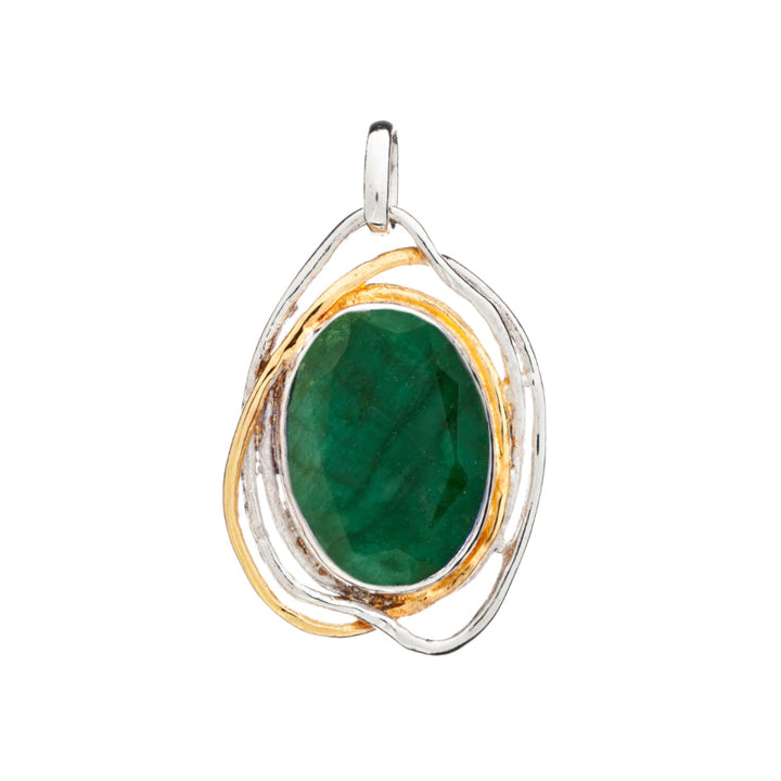 A Cosmos Pendant Large in various gemstones by Gallardo & Blaine Designs featuring a large, oval green gemstone set in an intricate silver and gold wireframe design. The frame loops around the stone, creating a modern yet medieval design. This statement gemstone pendant has a small loop at the top for attaching a chain or necklace.