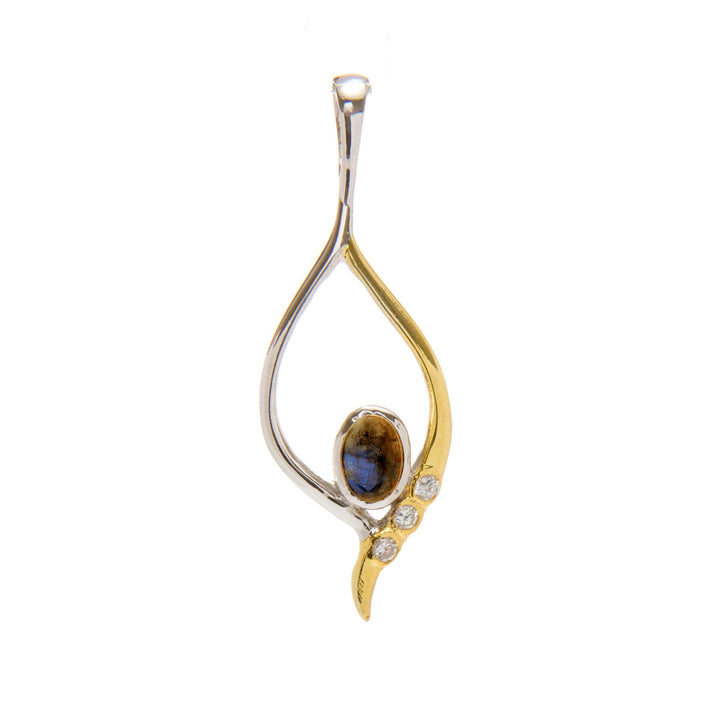 This Desert Star Pendant in various gemstones by Gallardo & Blaine Designs boasts an elegant, teardrop-shaped design with a mix of sterling silver and gold vermeil tones. A polished oval black stone centers the piece, flanked by three small clear gemstones set diagonally on a gold branch. The pendant is suspended from a thin bail.