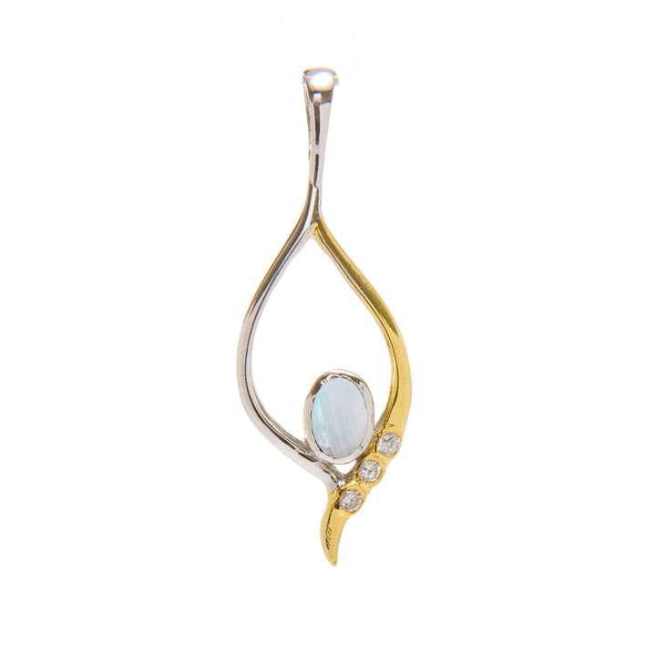 The Desert Star Pendant in various gemstones by Gallardo & Blaine Designs is crafted with a combination of sterling silver and gold vermeil, forming an elegant open teardrop shape. The design features an opalescent oval gemstone at its center, accompanied by three small, round diamonds along the gold curve.