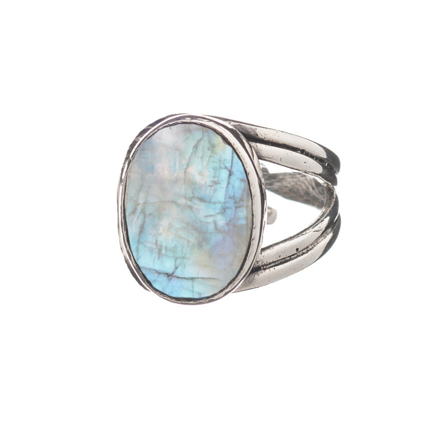 A chunky statement ring crafted from sterling silver, featuring a large, oval-shaped, iridescent gemstone with shades of blue and green. The band is split into three sections on either side of the stone, giving a unique and elegant design. The Dewberry Ring in various gemstones by Gallardo & Blaine Designs is displayed against a plain white background.