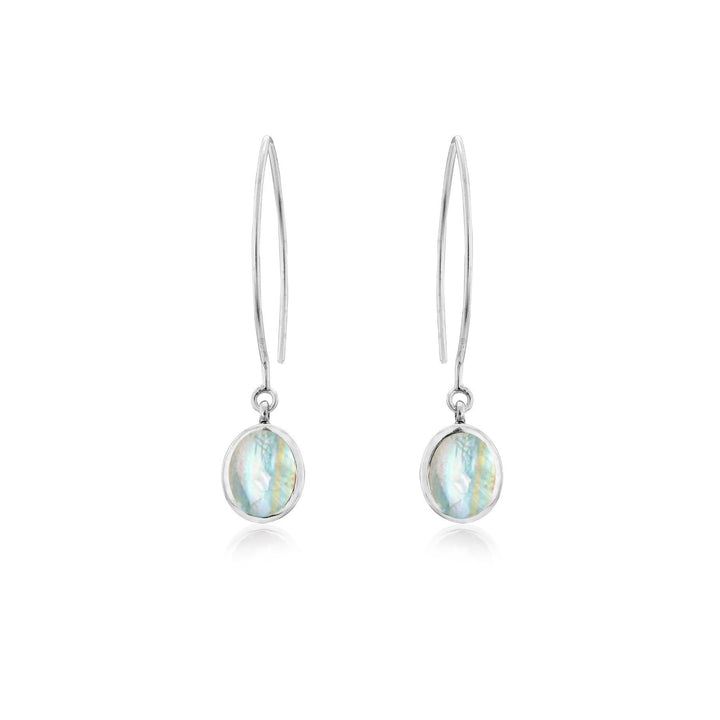 The Dew Drop Earrings in various gemstones by Gallardo & Blaine Designs feature oval-shaped, iridescent gemstones. The sterling silver earrings have a sleek and elegant design with a thin hook and a single hanging stone that reflects various shades of blue and green.