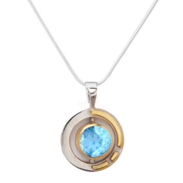 The Elodie Pendant in silver gold & various gemstones by Gallardo & Blaine Designs showcases a modern, geometric design with both sterling silver and gold vermeil accents. Its circular pendant features a bright blue gemstone at the center, exuding an Art Deco charm. The thin, delicate chain perfectly complements the bold elegance of this piece.