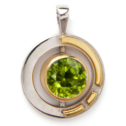 The Elodie Pendant in silver gold & various gemstones by Gallardo & Blaine Designs is a stunning Art Deco piece, featuring a round, sterling silver and gold vermeil design. At its center lies a green, faceted gemstone surrounded by geometric gold accents, including a partial circle and several bars. This elegant pendant makes any outfit sparkle.