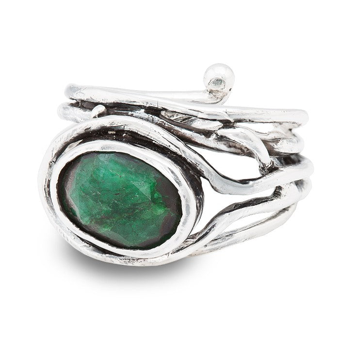 A Gallardo & Blaine Designs Fossil Ring in silver & various gemstones featuring an intricately designed, multi-band structure holding a large, oval-cut green gemstone at its center. The adjustable ring has a sculptural appearance with organic, flowing lines around the gemstone.