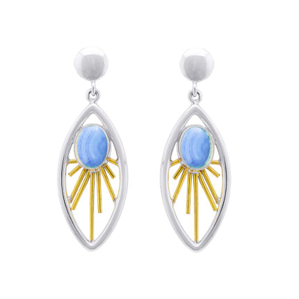 A pair of elegant **Goddess Earrings in various gemstones** by **Gallardo & Blaine Designs** featuring a sterling silver oval-shaped frame with a central light blue stone. Gold decorative elements radiate out from the gemstone drop, resembling sun rays. The earrings are topped with shiny silver studs.