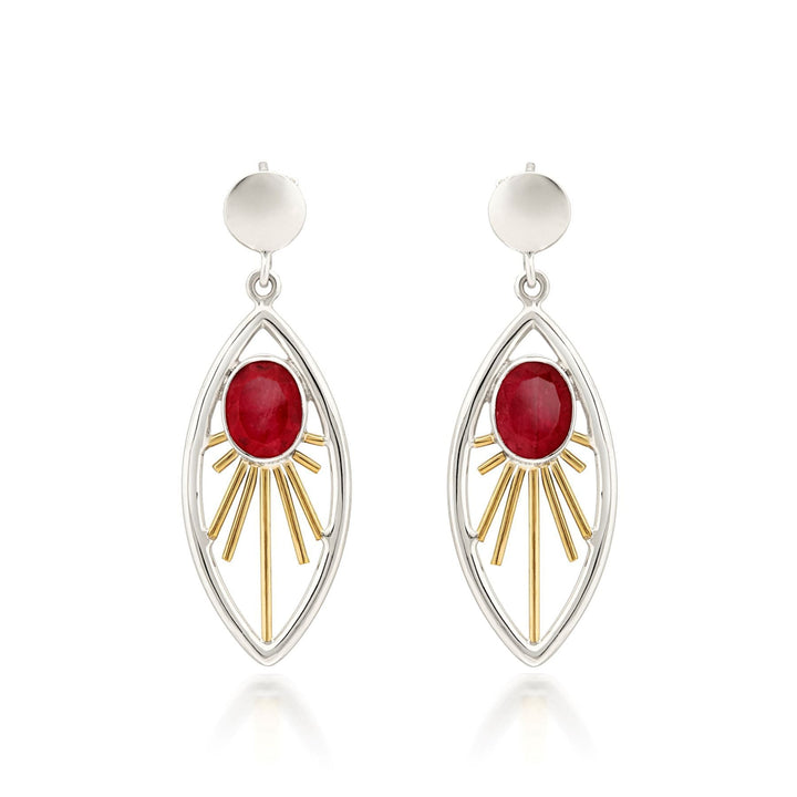 A pair of elegant Goddess Earrings in various gemstones featuring red oval gemstones set in the center of openwork marquise-shaped frames. The frames are adorned with gold-tone rays radiating from the gemstones, and the sterling silver and gold earrings are finished with simple round studs at the top. These beautiful earrings are designed by Gallardo & Blaine Designs.