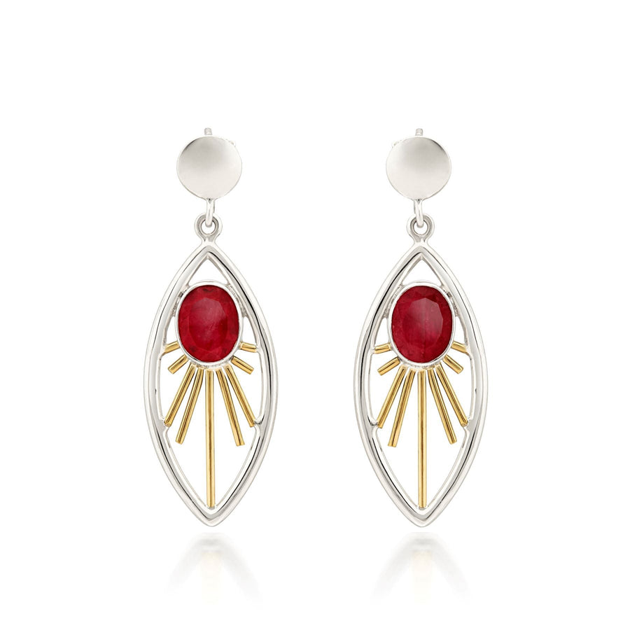 A pair of elegant Goddess Earrings in various gemstones featuring red oval gemstones set in the center of openwork marquise-shaped frames. The frames are adorned with gold-tone rays radiating from the gemstones, and the sterling silver and gold earrings are finished with simple round studs at the top. These beautiful earrings are designed by Gallardo & Blaine Designs.