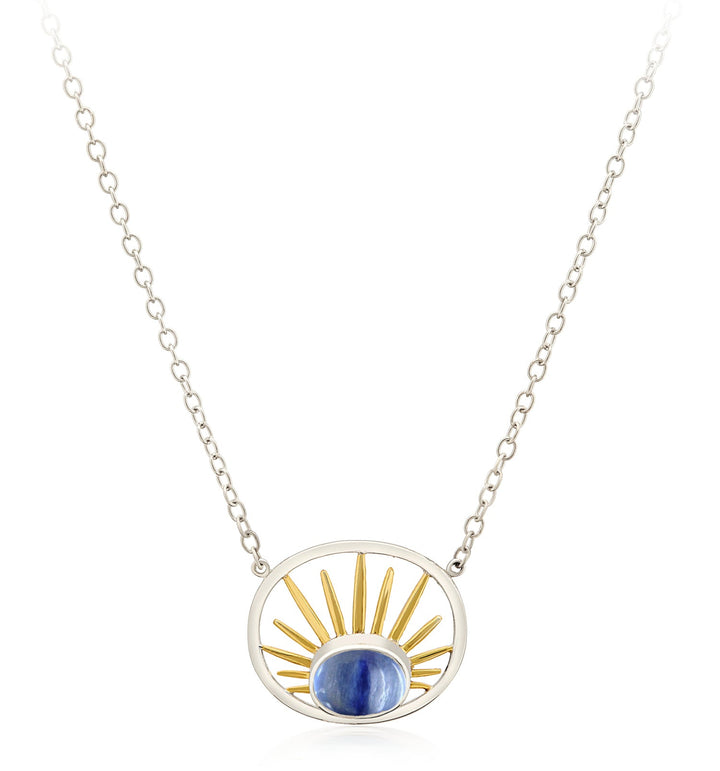 The Gallardo & Blaine Designs Goddess Necklace Small in various gemstones features a sterling silver chain adorned with a stunning blue oval gemstone at the center. Framed by a silver oval, gold sunray-like spokes radiate from the gemstone, beautifully resembling a rising sun.