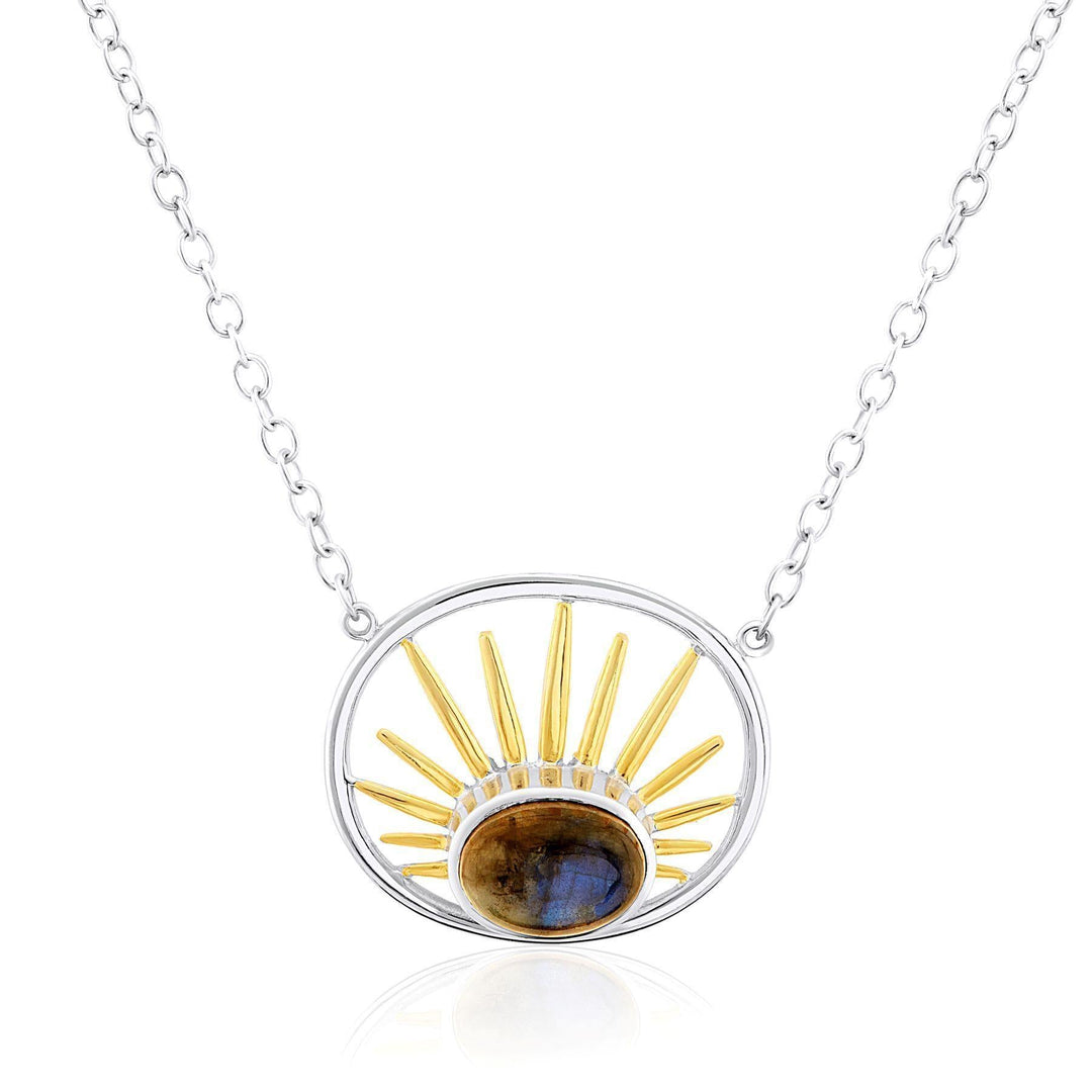 A sterling silver necklace with a circular pendant displays golden sun rays emanating from a central dark gemstone. The pendant features an open circular frame, and the chain is adorned with small round links. This exquisite piece by Gallardo & Blaine Designs is truly a Goddess Necklace Small in various gemstones.