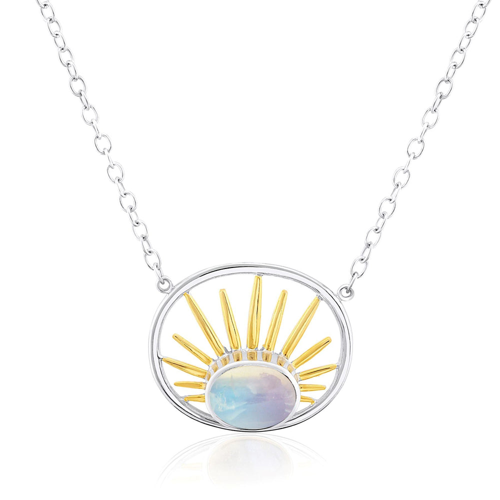 The Goddess Necklace Small in various gemstones by Gallardo & Blaine Designs features a sterling silver chain and a circular pendant with a design resembling a sun. The pendant has golden rays radiating from a central opalescent stone, creating a captivating sunburst effect.