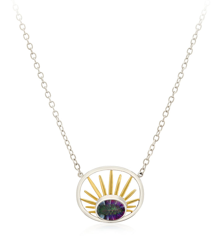 A stunning Goddess Necklace Small in various gemstones from Gallardo & Blaine Designs features a pendant with a central, oval, multicolored gemstone. The gemstone is framed by a circular sterling silver outline with golden sunburst rays extending upwards, all connected to a delicate silver chain.