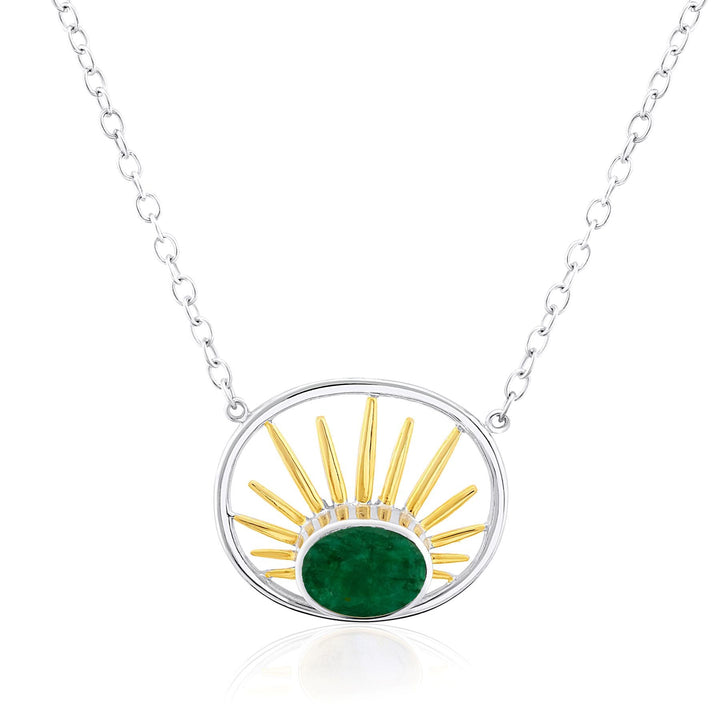 A Goddess Necklace Small in various gemstones featuring a circular pendant with a green gemstone at the bottom center. Golden sunray-like spikes emanate upward from the gem within the sterling silver round frame by Gallardo & Blaine Designs. The pendant is attached to a delicate silver chain.