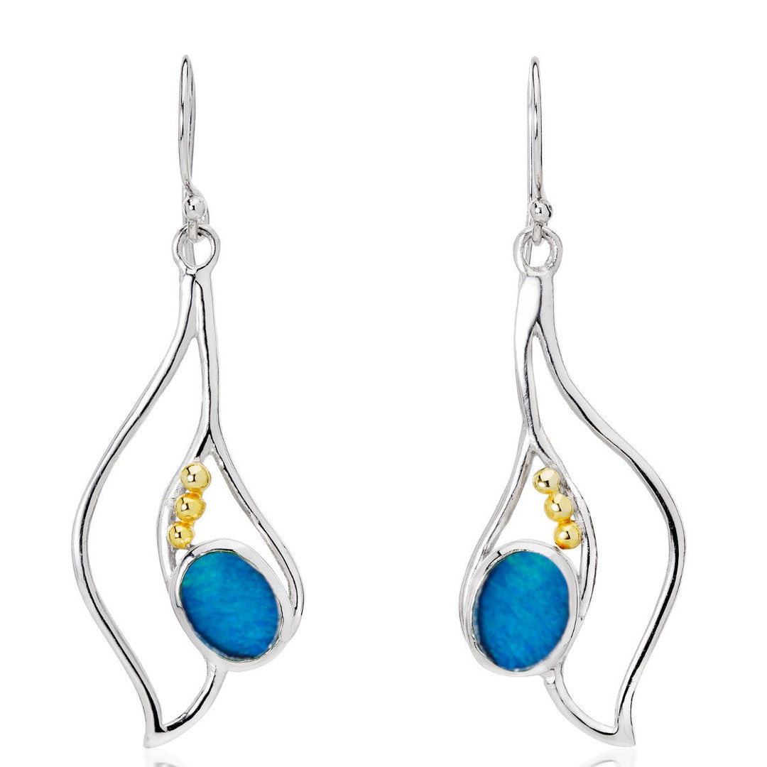 Introducing the Iris Earrings in various gemstones by Gallardo & Blaine Designs: a pair of drop earrings featuring an elegant silver wavy design. Each earring cradles a blue oval gemstone and has small gold-tone beads accenting the silver & gold framework. These exquisite gemstone earrings have fish hook backings for easy wearing.