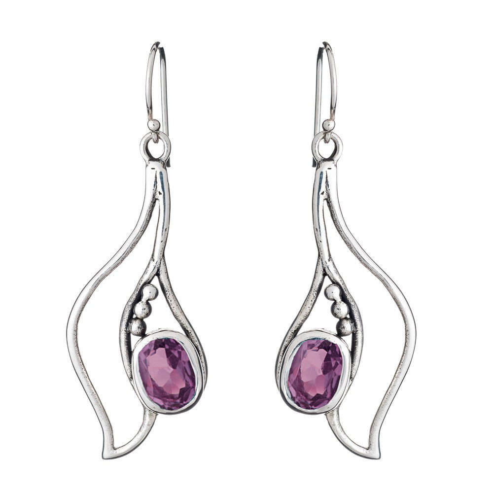 Introducing the Iris Earrings in various gemstones from Gallardo & Blaine Designs: a pair of elegant silver & gold drop earrings featuring an abstract, wavy design. Each earring is adorned with a purple gemstone in an oval shape, surrounded by small silver bead embellishments. These exquisite gemstone earrings have hook fastenings.