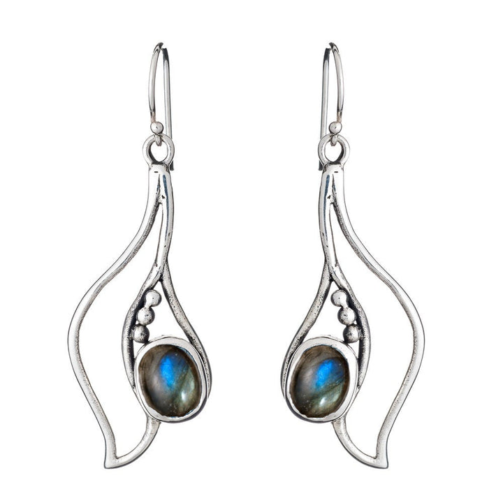 Introducing the Iris Earrings in various gemstones by Gallardo & Blaine Designs: a stunning pair of silver and gold earrings featuring an abstract, flowing design with small ball accents. Each earring showcases an oval labradorite gemstone with iridescent blue and green hues, securely set in the center, and equipped with hook closures.