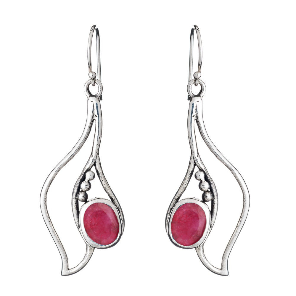 The Iris Earrings in various gemstones by Gallardo & Blaine Designs are a pair of stunning silver dangle gemstone earrings with flowing, abstract designs. Each earring features a pink oval gemstone set in the center, complemented by three small silver bead accents. The earrings have hooks at the top for fastening, adding elegance to any outfit.