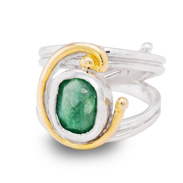 A silver Art Nouveau ring featuring a large, rough-cut green gemstone encased in a gold bezel setting. The band of the ring is smooth and polished, with a slightly spiraled design that meets the gemstone setting, offering an adjustable design for perfect fit and comfort. This exquisite piece is known as the Jasmine Ring in various gemstones by Gallardo & Blaine Designs.