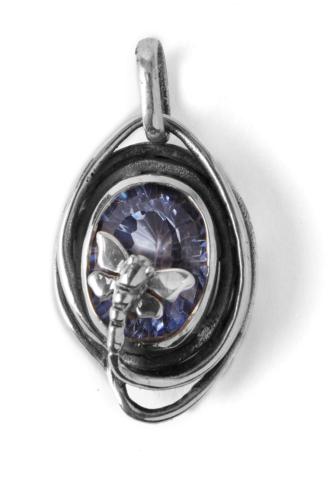 A close-up image of the Lagoon Pendant Small in various gemstones by Gallardo & Blaine Designs featuring a large blue gemstone in the center, encircled by silver loops. The gemstone is adorned with a silver dragonfly figure. The design is intricate and slightly rustic, with detailed metalwork and a polished finish.