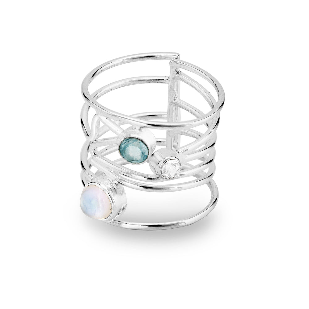 A Lattice Ring in various gemstones by Gallardo & Blaine Designs featuring three gemstones: a white opal, a blue topaz, and a clear quartz. The band has an open, lattice design with the stones set at different points across the layers, creating a contemporary and intricate appearance.