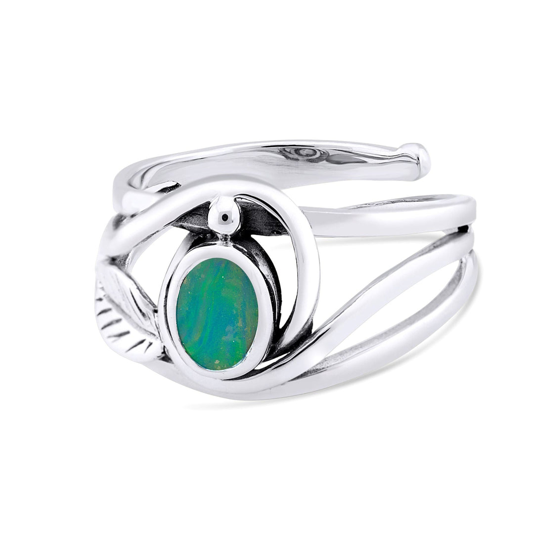 A Leaf Ring in Silver Gold & various gemstones from Gallardo & Blaine Designs featuring an oval-shaped green and blue opal stone. The elegant gemstone ring has an intricate swirling design that wraps around the opal, giving it a unique appearance reminiscent of a delicate leaf ring.