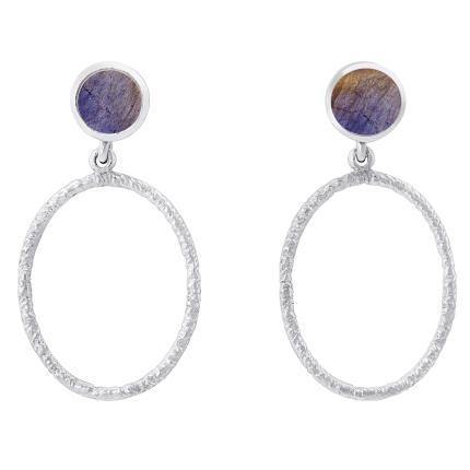 A pair of Lunar Earrings in various gemstones by Gallardo & Blaine Designs featuring a circular post with a purple gemstone, and a large, textured open hoop hanging below each post. The design seamlessly blends elegance with a touch of rustic charm.