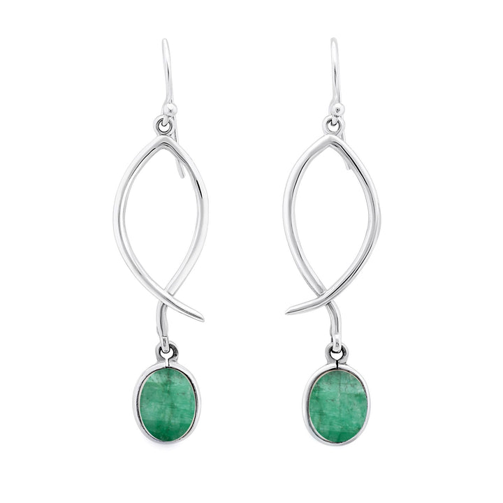 These versatile Lupin Earrings in various gemstones by Gallardo & Blaine Designs showcase an elegant drop silver design with a twisted structure. Each earring features a small oval green gemstone, likely an emerald, set in a silver frame that dangles gracefully. With hook-style fastenings, these earrings are perfect for any occasion.