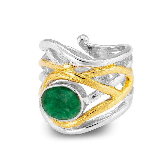 Introducing the Mayhem Ring in various gemstones by Gallardo & Blaine Designs: A silver and gold-toned ring featuring an intricate, intertwined design. The band showcases a prominent green gemstone as the centerpiece, adding a vibrant pop of color to this elegant, medieval-inspired jewelry piece.