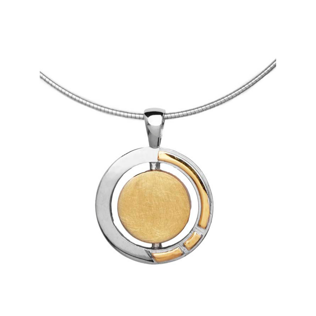 A necklace featuring the Urú Large Pendant & Chain with a modern Celtic pendant with a circular design. The pendant combines sterling silver & gold vermeil, with a gold central disc and a partially encircling silver frame, accented by small gold details. This elegant piece by Gallardo & Blaine Designs hangs from a sleek, silver chain.