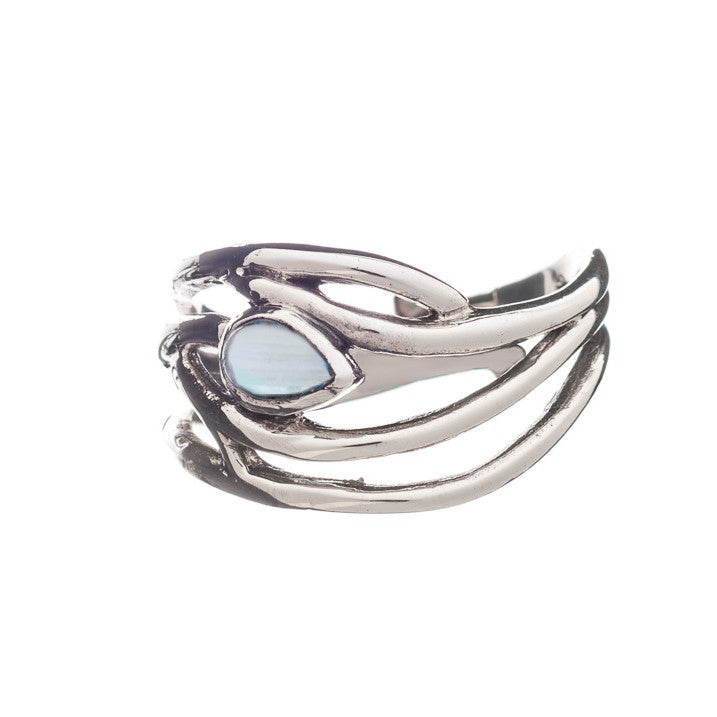 A sleek silver ring featuring a unique design with intertwined bands and a central teardrop-shaped opal gemstone. The Peacock Ring in various gemstones by Gallardo & Blaine Designs boasts an adjustable feature in both silver and gold, offering an exquisite blend of smooth, polished metal work for a contemporary look.