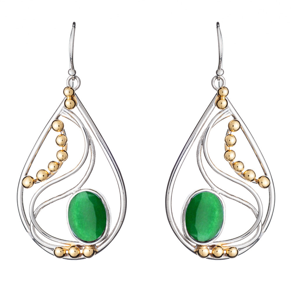 The Phoenix Earrings in various gemstones by Gallardo & Blaine Designs are a pair of elegant drop earrings featuring silver frames with decorative gold beads. Each earring showcases a large oval green stone set in the center, surrounded by intricate silver curves. These sophisticated silver and gold earrings hang gracefully from simple hooks.