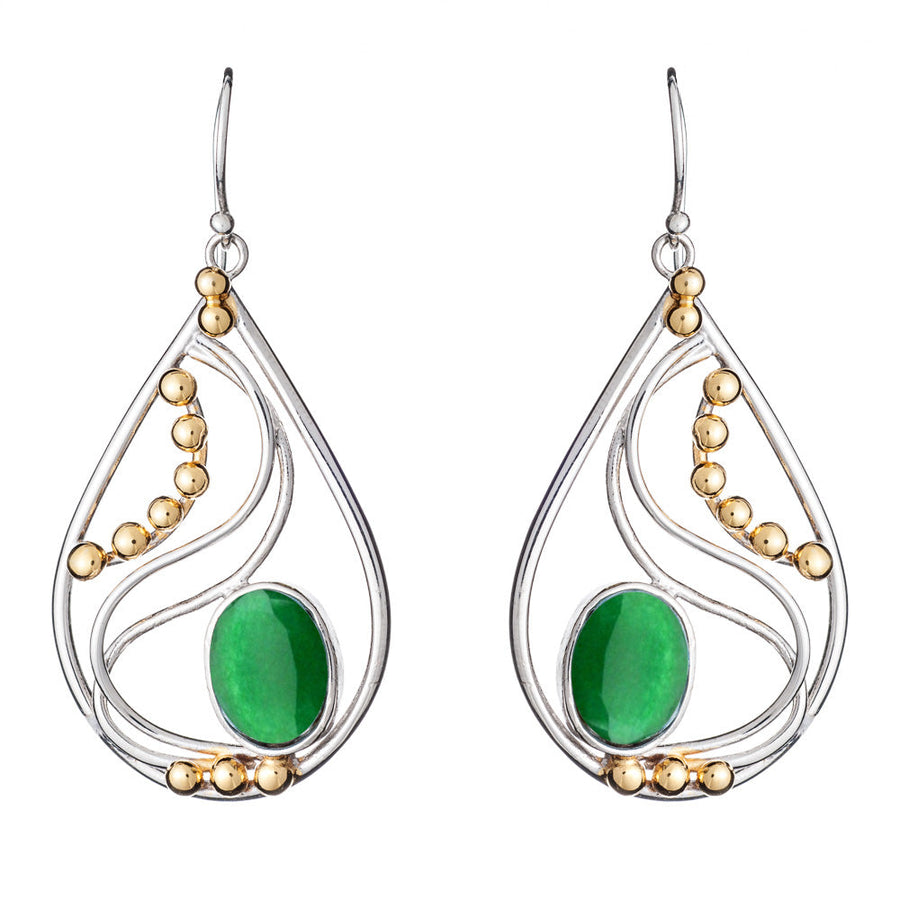 The Phoenix Earrings in various gemstones by Gallardo & Blaine Designs are a pair of elegant drop earrings featuring silver frames with decorative gold beads. Each earring showcases a large oval green stone set in the center, surrounded by intricate silver curves. These sophisticated silver and gold earrings hang gracefully from simple hooks.