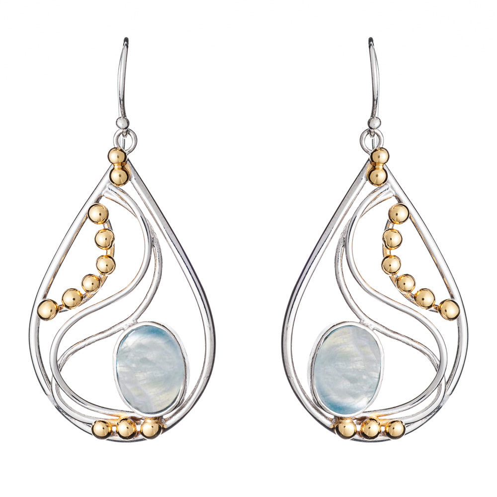 A pair of Phoenix Earrings in various gemstones featuring a combination of silver and gold tones. These elegant teardrop-shaped earrings by Gallardo & Blaine Designs have a large central opalescent stone, accented by curved silver lines and small gold spherical beads arranged along the inner edges.