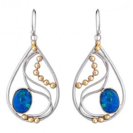 Introducing the Phoenix Earrings in various gemstones by Gallardo & Blaine Designs: a pair of elegant drop earrings featuring intricate silver wire designs with small gold bead accents and blue oval gemstones at the bottom center. These silver and gold earrings have hook fastenings for pierced ears, combining timeless elegance with modern flair.