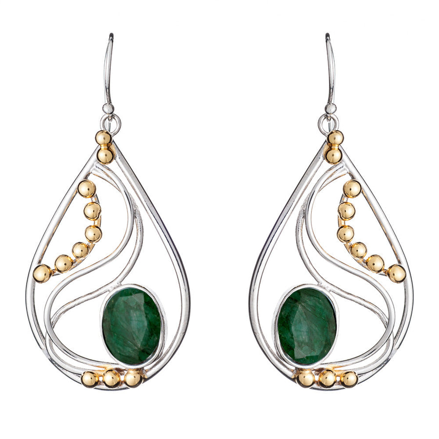 These elegant Phoenix Earrings in various gemstones from Gallardo & Blaine Designs are teardrop-shaped with a blend of silver and gold-colored elements. Each earring features a large green gemstone at the center, complemented by a wavy silver design and gold-colored beads. The silver and gold earrings have a hook for wearing.