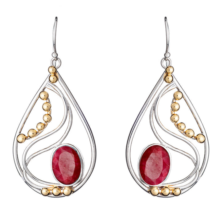 Introducing the Phoenix Earrings in various gemstones by Gallardo & Blaine Designs: a pair of elegant drop earrings featuring stunning red oval gemstones at the center of teardrop-shaped silver frames. Adorned with small gold beads and intricate silver swirls, these silver and gold earrings hang gracefully from simple hooks.