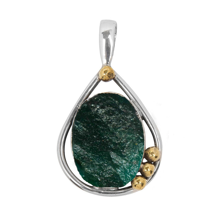 The Poppy Pendant Small in various gemstones by Gallardo & Blaine Designs features a large oval green gemstone set in a teardrop-shaped sterling silver frame. Three small gold-colored beads at the lower right side add a touch of contrast to the design, and the pendant boasts a sleek, polished appearance.