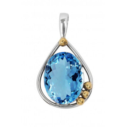 The Poppy Pendant Small in various gemstones, crafted in sterling silver by Gallardo & Blaine Designs, features a large, faceted blue gemstone at its center. This stunning piece has a teardrop-shaped frame adorned with three small gold beads on one side. The vibrant, deep blue gemstone reflects light elegantly.