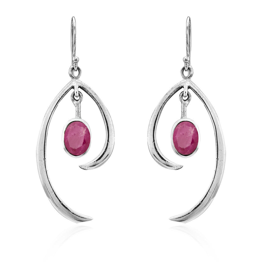 The Gallardo & Blaine Designs Primrose Earrings in various gemstones are a pair of sterling silver drop earrings featuring an elegant, curved design. Each earring showcases an oval-shaped pink gemstone hanging in the center. The minimalist elegance of the simple hooks adds to the delicate and refined aesthetic of this jewelry.