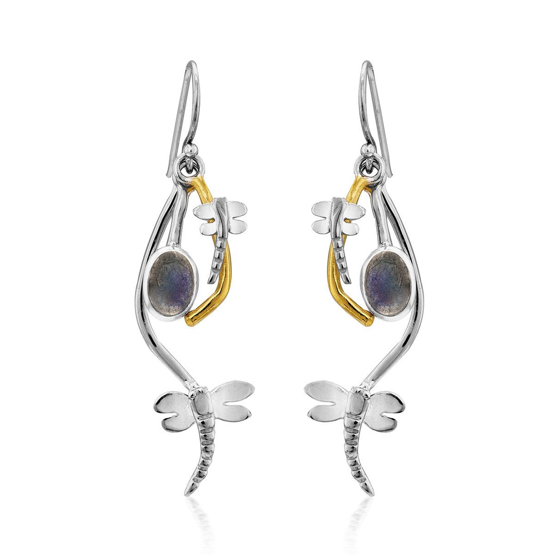 A pair of Ripple Earrings in various gemstones by Gallardo & Blaine Designs featuring a whimsical dragonfly design. Each silver dangle earring has a curved body, gold accents, and a round iridescent gemstone. The earrings have a hook for wearing.