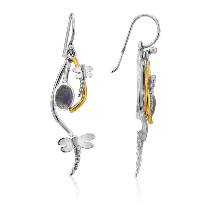 A pair of delicate earrings featuring a silver dragonfly charm, an oval gemstone, and a gold plate accent piece. These Ripple Earrings in various gemstones by Gallardo & Blaine Designs have hook-style closures and combine intricate detailing with a mix of metallic and natural elements.