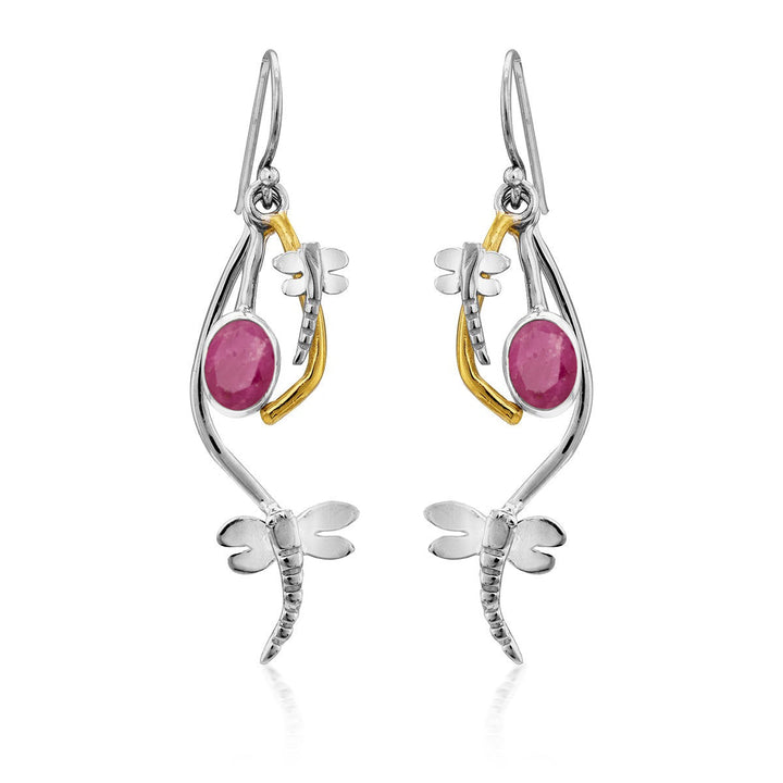 A pair of elegant, delicate Ripple Earrings in various gemstones featuring a dragonfly design. Each earring has a silver dragonfly with detailed wings, a curved silver accent, and a bright pink oval gemstone. A golden accent links the dragonfly to the hook, creating an intricate look for these Gallardo & Blaine Designs silver dangle earrings.