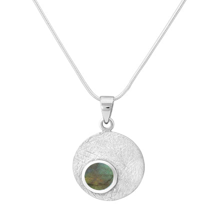 The Gallardo & Blaine Designs Selene Necklace Silver - Small in various gemstones showcases a silver pendant with a textured surface and a smaller circular, iridescent stone in hues of green and blue at the bottom left corner. It features a delicate, Sterling silver chain that complements its elegant design.