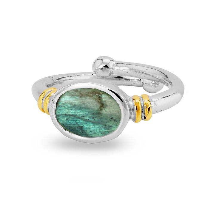 A Senna Ring in various gemstones by Gallardo & Blaine Designs featuring an oval-shaped green gemstone in the center. The band, with gold accents on either side of the stone and a small silver ball on one end, offers an adjustable appearance. This Art Nouveau ring has a polished, reflective surface.