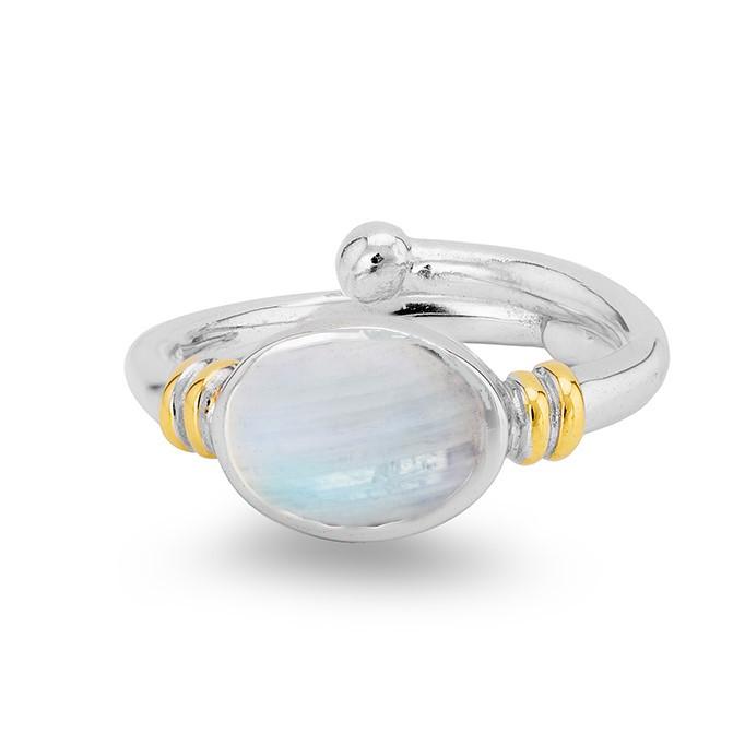 A Gallardo & Blaine Designs Senna Ring in various gemstones featuring an oval, translucent white centerpiece, adorned with small gold accents on either side of the stone setting. The band is smooth with a polished finish. The gemstone displays subtle iridescent reflections, reminiscent of Art Nouveau elegance.